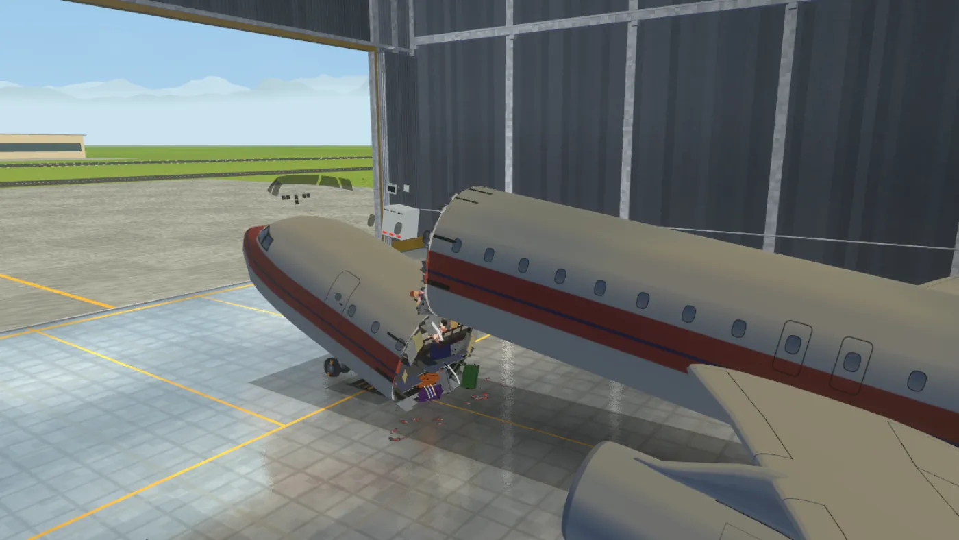 The airliner in the test hangar, torn in two just behind the cockpit, with seats and luggage spilling onto the hangar floor.